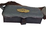 a black box with a gold leaf on top of it