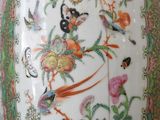 a vase that has a bird and flowers on it