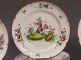 three plates with designs on them are sitting on a table