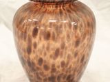a vase that is sitting on a white surface