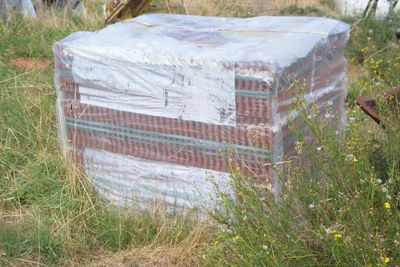 a large box sitting in the middle of a field