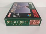 the box of mystic quest legend is sitting on a white surface