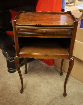 a small wooden table with a drawer on it