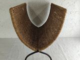 an image of a hat on a stand against a white wall