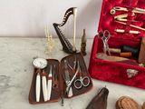 a red case with scissors, scissors, and other items in it