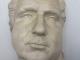 bust of a man wearing a white shirt and a black tie