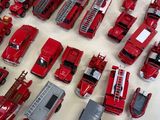 a lot of toy fire trucks that are on the table