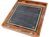 a wooden box with a black leather cover on it