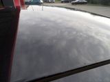 a parking meter on the roof of a car in a parking lot