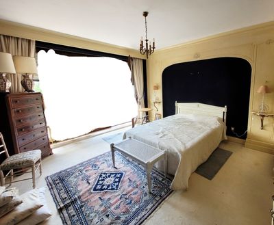 une chambre avec un grand lit et un lustre