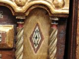 a close up of a wooden cabinet with a clock on top of it