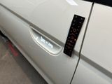 a close up of a car door handle with a sticker on it