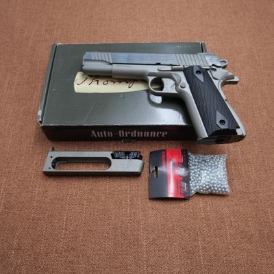 a gun that is sitting on a table next to a card