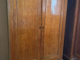 an image of a wooden armoire sitting on top of a hard wood floor