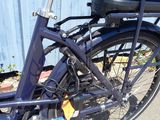 a blue bicycle parked in front of a blue building