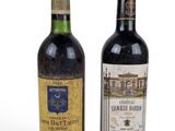 two bottles of wine sitting next to each other on a white surface