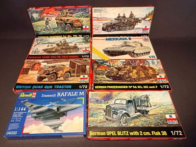 six boxed boxes of model military vehicles on a table