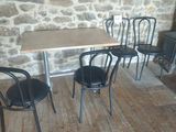 three chairs and a table in front of a wood burning stove