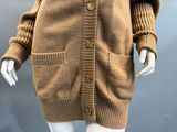 a close up of a mannequin wearing a brown cardigan sweater