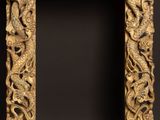 a wooden frame with a dragon and fish design on it