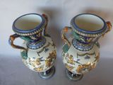 two vases that are sitting on a table
