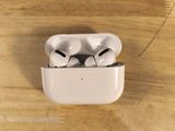 a pair of airpods sitting on top of a wooden table