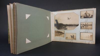 an open book with pictures of people and a plane in it