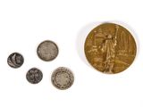 an image of a gold medal and some coins on a white surface