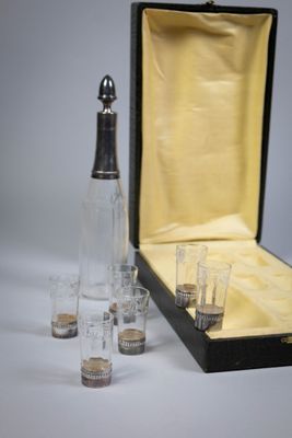 a bottle of liquor and glasses in a case