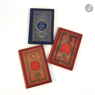 three small books sitting on top of each other on a white surface