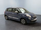 the small blue car is parked in a room with a black floor