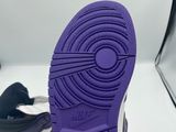a close up of a pair of purple sneakers on a white surface