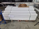 a pile of white plates on a pallet in a warehouse
