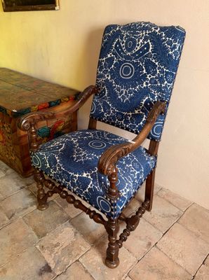 une chaise bleue et blanche posée devant un coffre