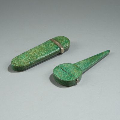 two small green objects on a white surface