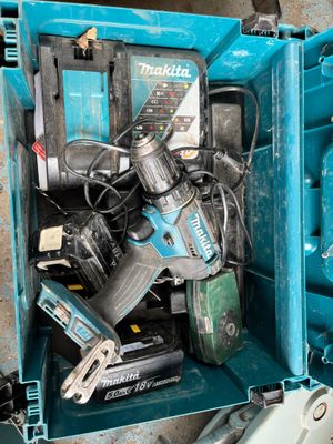a blue tool box filled with power tools on the floor