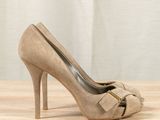 beige sued high heel pumps with bow detail on the toe