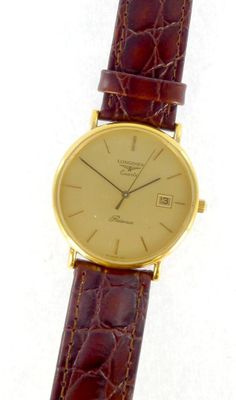 a close up of a wrist watch with a brown leather strap