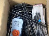 a box full of train tracks and wires in it
