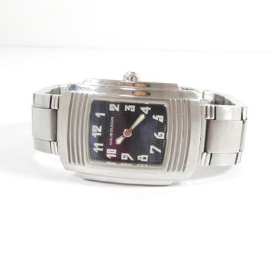 a close up of a watch on a white surface
