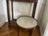 a small table with a marble top and a small stool