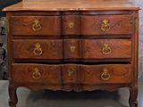 a wooden chest of drawers with gold handles on it