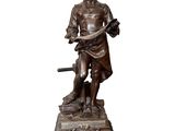 bronze statue of a man holding a dog and a bird