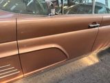 a brown car parked on the side of the street
