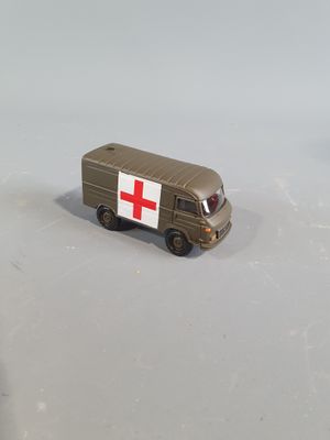 a toy ambulance truck with a red cross on it