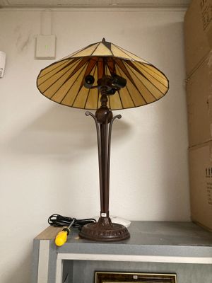 a lamp that is sitting on top of a microwave
