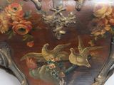 a clock with a painting of birds and flowers on it