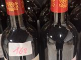 several bottles of wine are lined up on a shelf