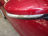 a close up of a red car door handle