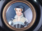 a black plate with a picture of a woman on it
